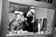 A bride getting her makeup put on by a makeup artist before the wedding.