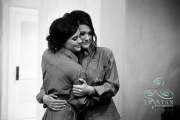 A bride hugging her sister before they start getting into the dress before a wedding.