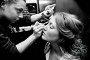 A bride getting her makeup done before a wedding.