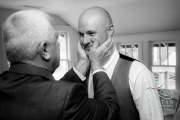 A groom having a tender moment with his father before the wedding.