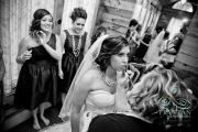 The bridesmaids look on approvingly as the bride gets her lip makeup touched up one last time.