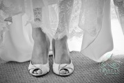 A close up of a bride's heels before she put down her dress.