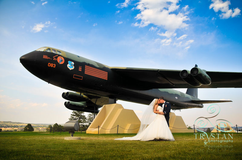 The bride and groom posing next to the B-52 monument on the Air Force Academy grounds.