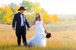 a bride and groom walking down the hill at the Ritz-Carlton Bachelor Gulch.