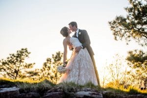 A bride and groom kissing during sunset at their weddings at Sanctuary Golf Course.