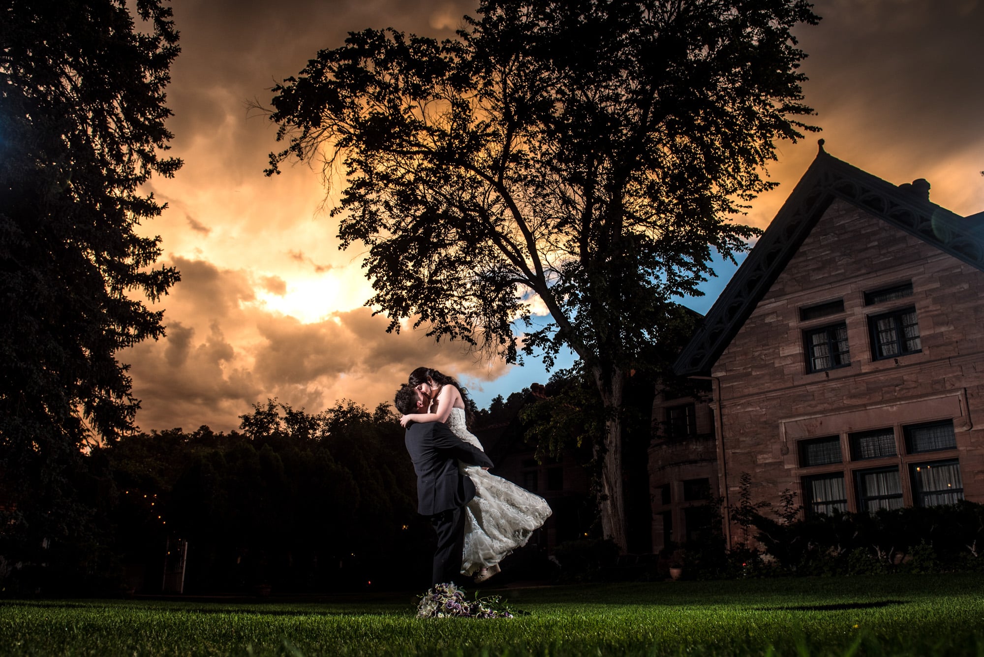 Weddings at The Briarhurst Manor - A bride and groom kissing at dusk.